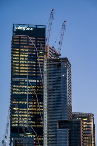 Skyscrapers under construction with cranes against blue sky