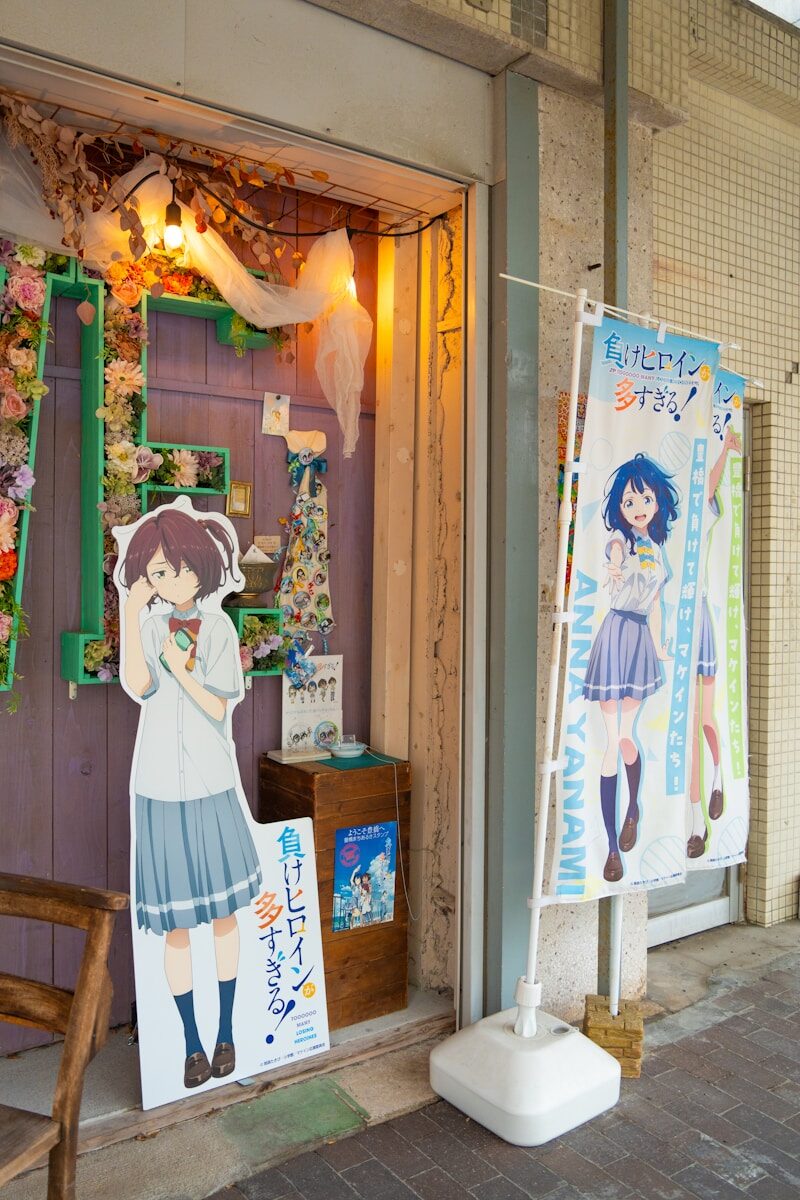 Anime character cutouts outside a shop entrance